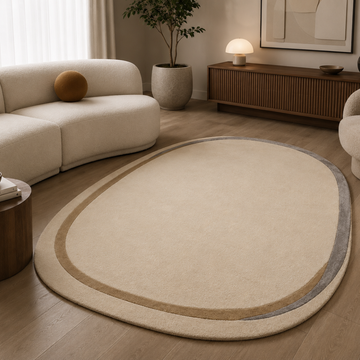 Luxury ivory minimalist oval rug in a modern neutral living room
