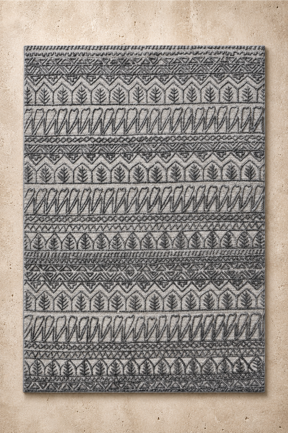 Ash Heritage handcrafted handloom over hand tufted ash grey New Zealand wool area rug featuring carved tribal leaf and geometric patterns