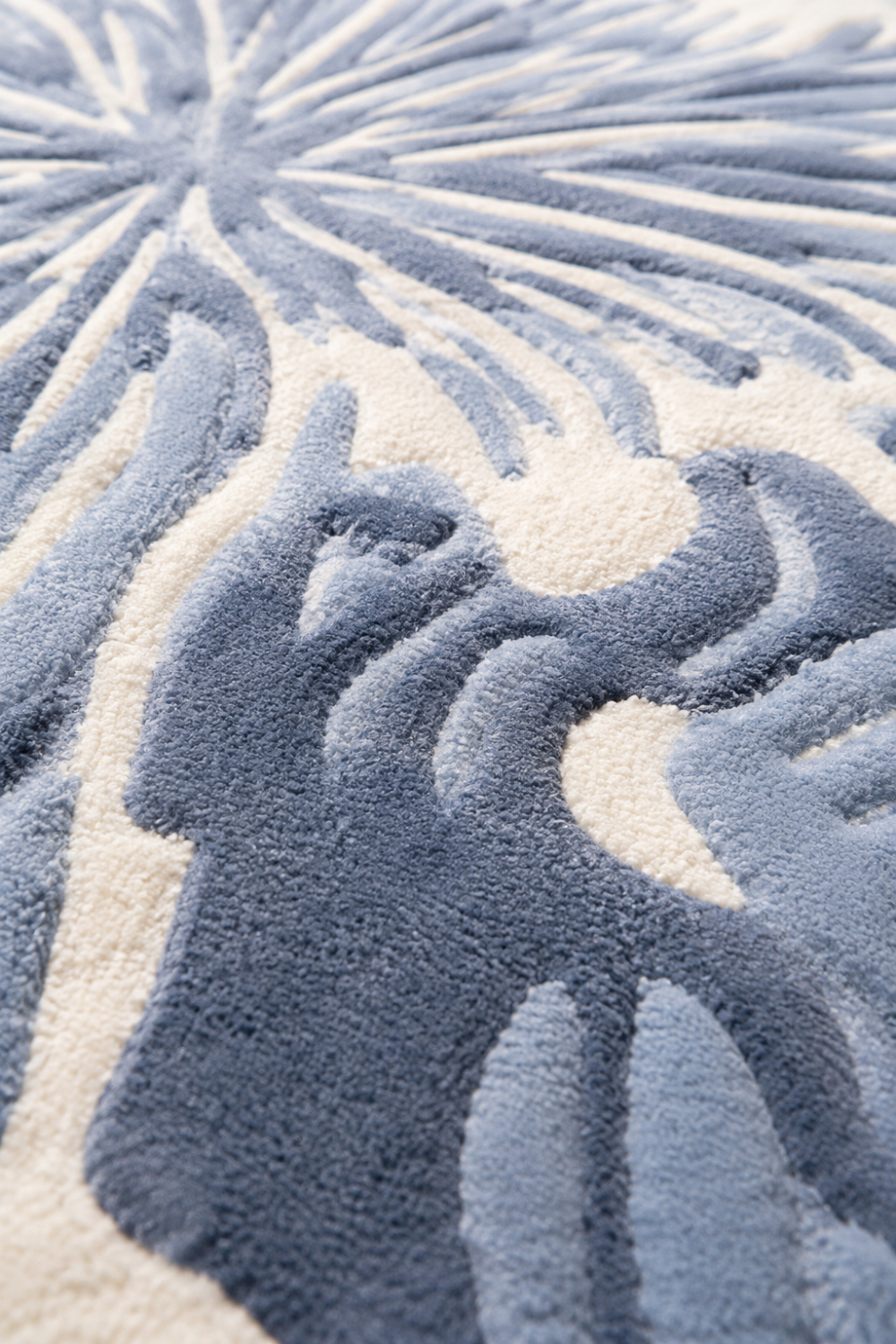 Close-up detail of Azure Bloom Organic Rug showcasing carved floral patterns, premium pile texture and handcrafted luxury finishing.