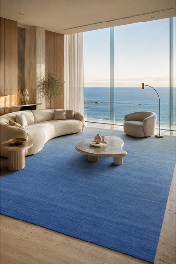 Azure Horizon luxury handloom New Zealand wool blue gradient area rug styled in a contemporary coastal living room