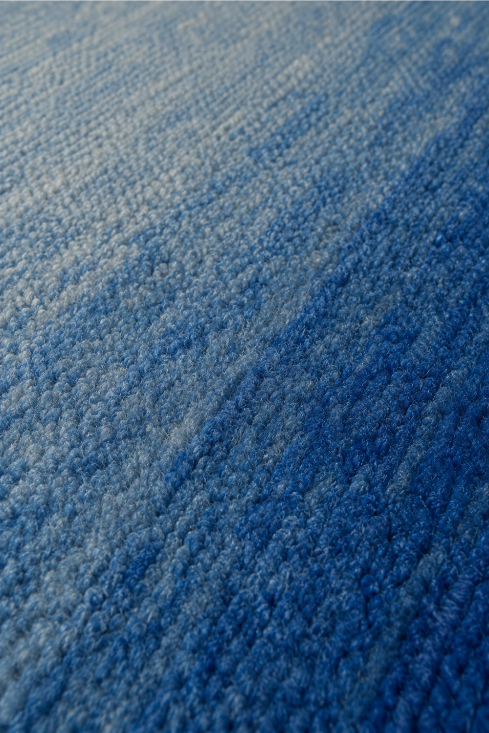 Close-up of the Azure Horizon handloom New Zealand wool rug showcasing its blue gradient texture and handcrafted weave