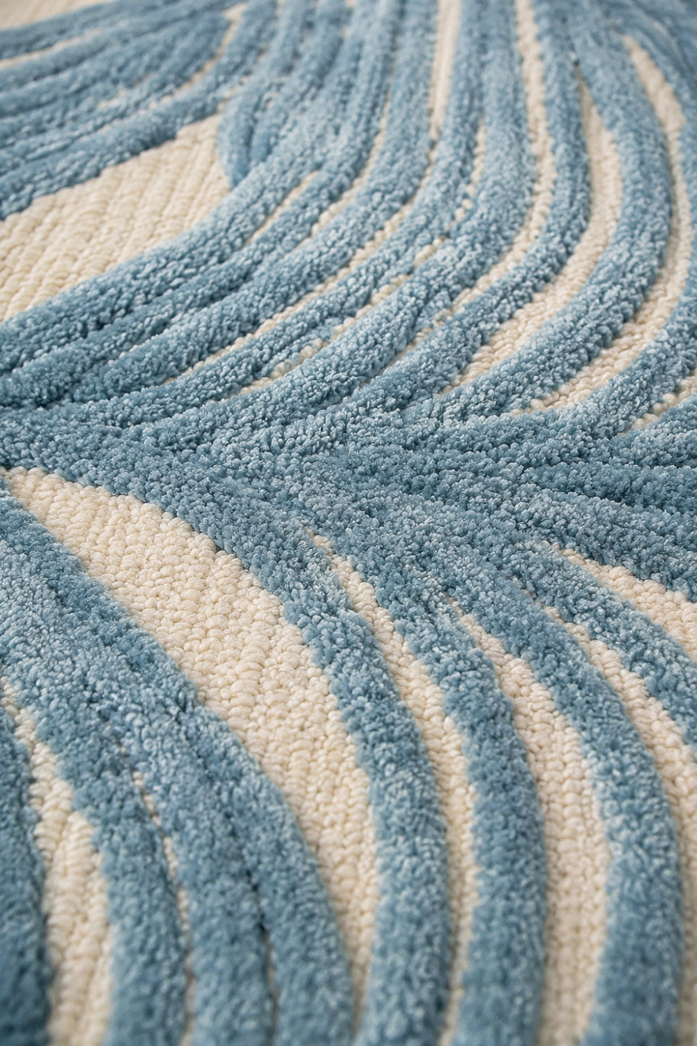 Close up texture detail of Azure Weave luxury hand tufted rug showing high low pile carving sculpted lines and premium artisan craftsmanship