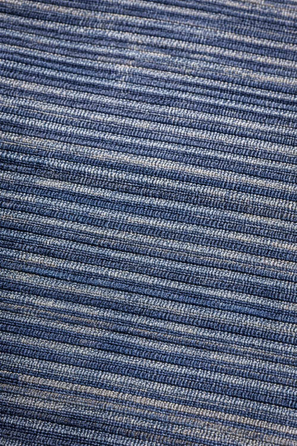 Close-up texture of the Blue Meridian handloom viscose rug showcasing handcrafted horizontal weaving and rich blue tonal variation.