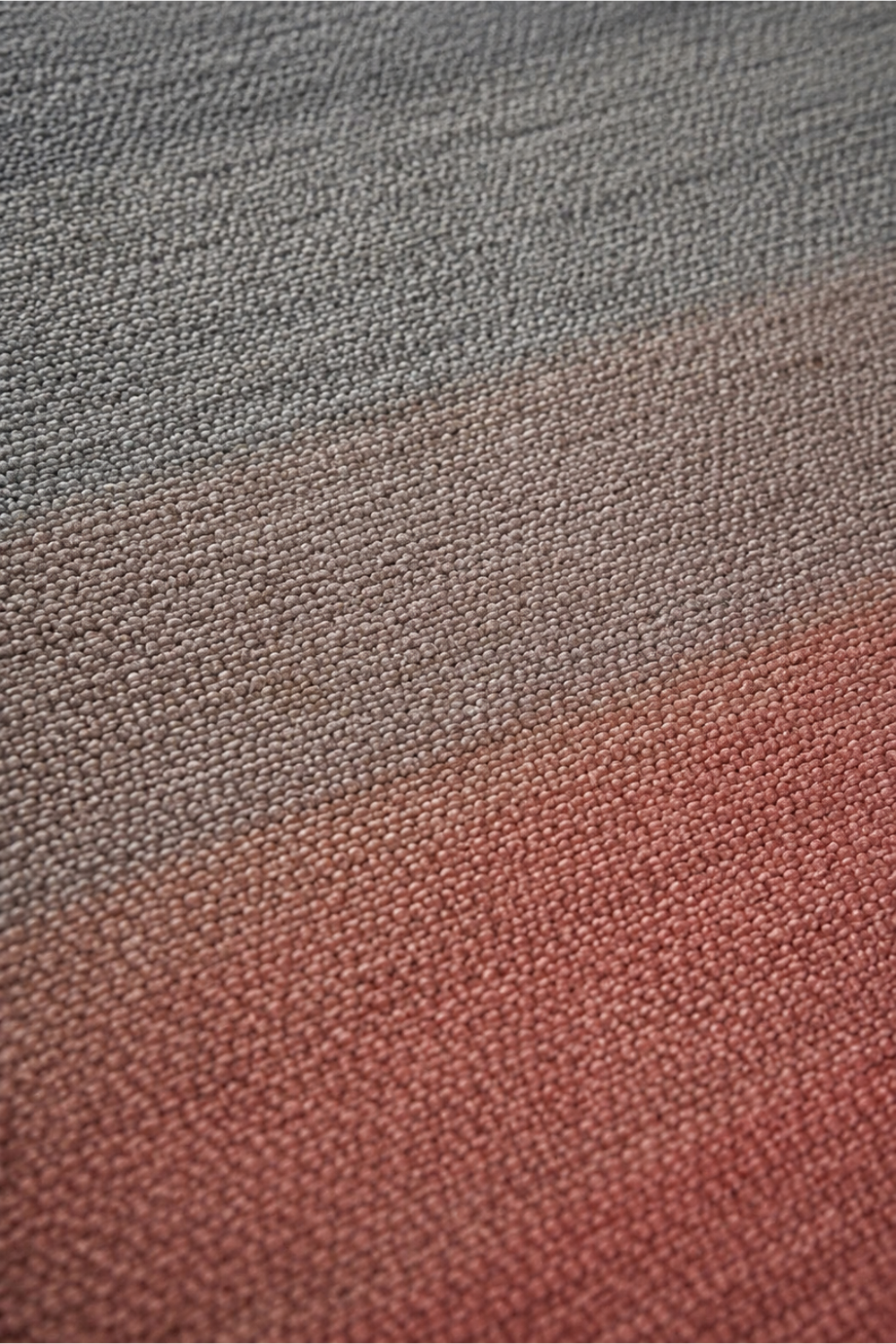 Close-up of the Blush Horizon handloom New Zealand wool rug showcasing premium wool texture and handcrafted layered gradient weave