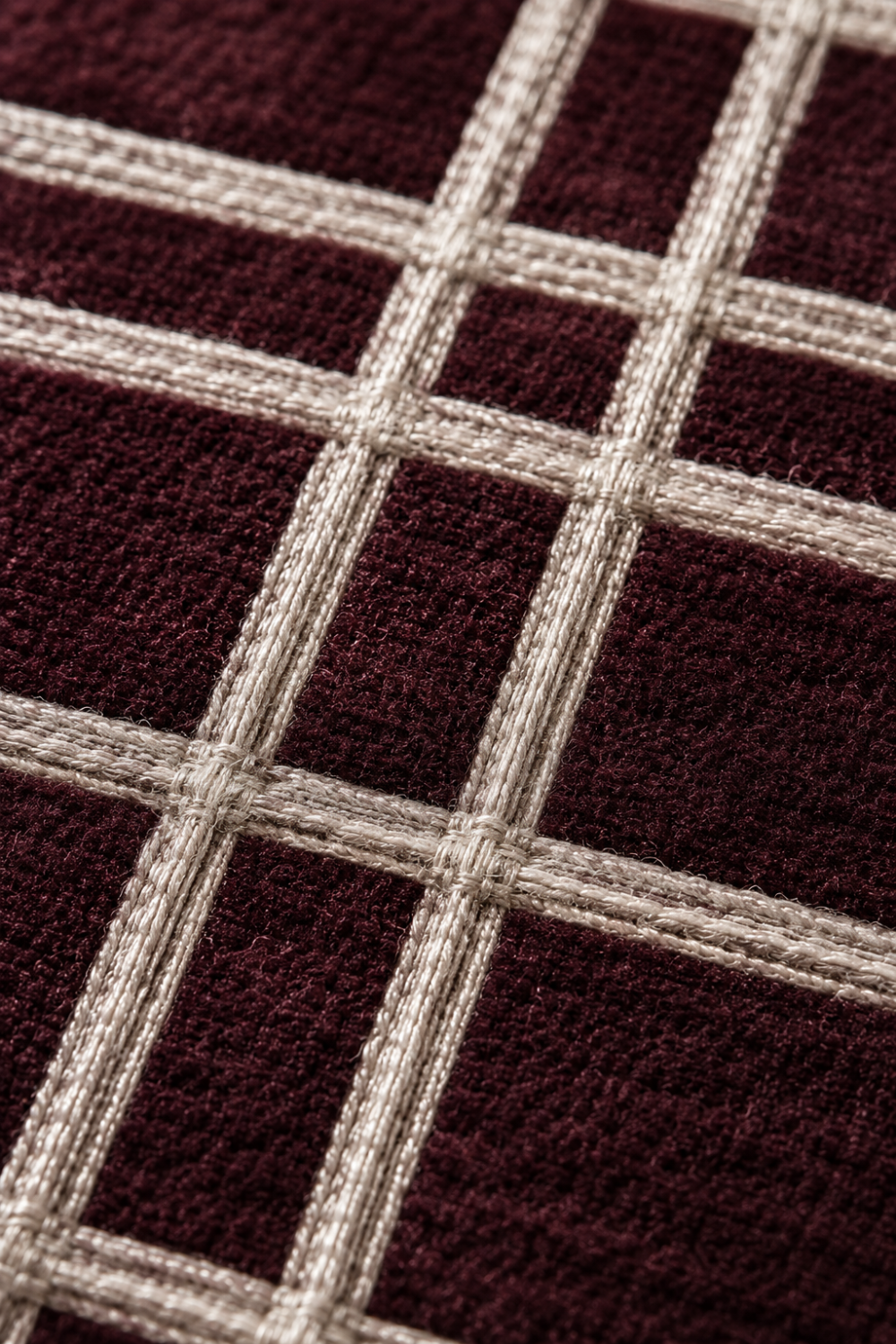 Close-up of the Bordeaux Grid handloom wool and viscose rug showcasing raised champagne-beige grid detailing, luxurious texture and artisan craftsmanship