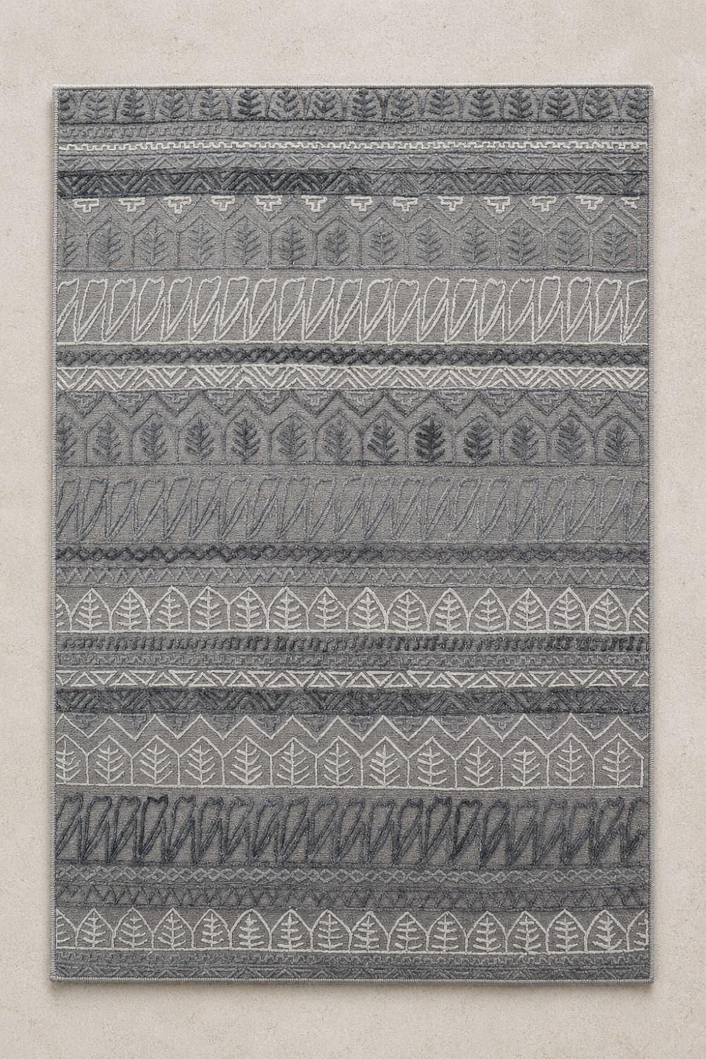 Botanical Rhythm handcrafted handloom over hand tufted grey New Zealand wool area rug featuring carved botanical leaf and geometric tribal stripe patterns