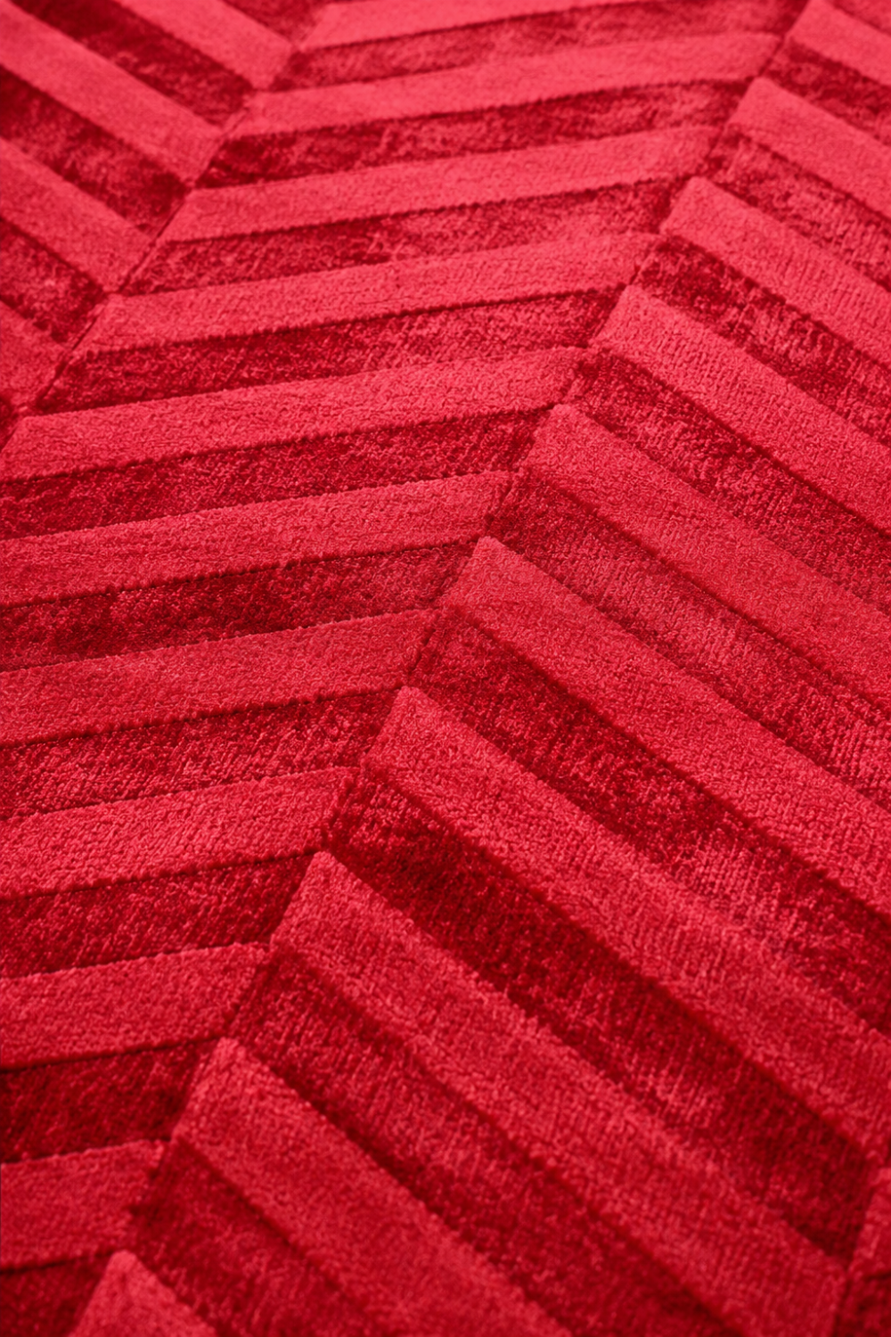 Close-up of the Crimson Chevron Rug showing handcrafted chevron texture, raised detailing, and luxurious Viscose Tencel Bamboo surface.