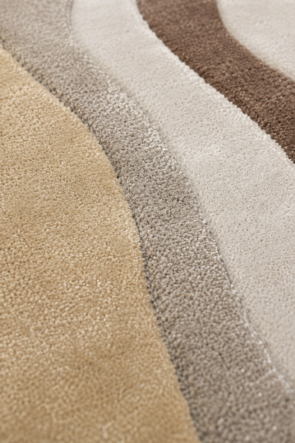 Close-up texture detail of Desert Contour organic rug showcasing premium craftsmanship and layered neutral tones.