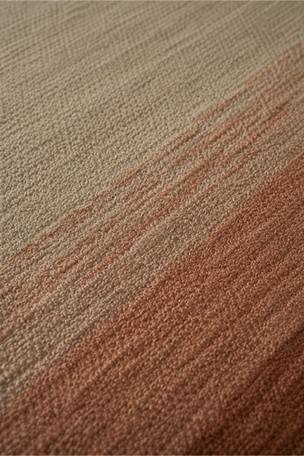 Close-up of the Desert Horizon handloom New Zealand wool rug showcasing soft tonal shading, handcrafted texture and warm terracotta colour transitions