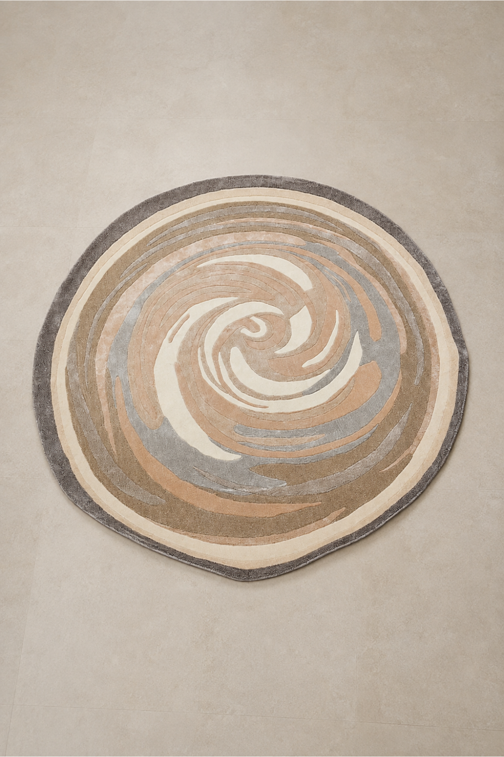 Desert Whirl Round Hand Tufted Rug featuring an organic swirl design in ivory, beige, taupe and soft grey tones.