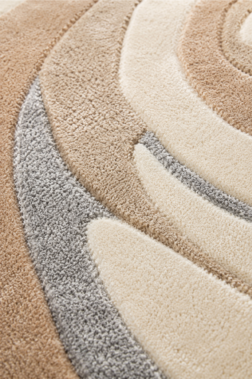 Close-up of the Desert Whirl Round Hand Tufted Rug showcasing plush pile, carved texture and handcrafted swirl detailing.