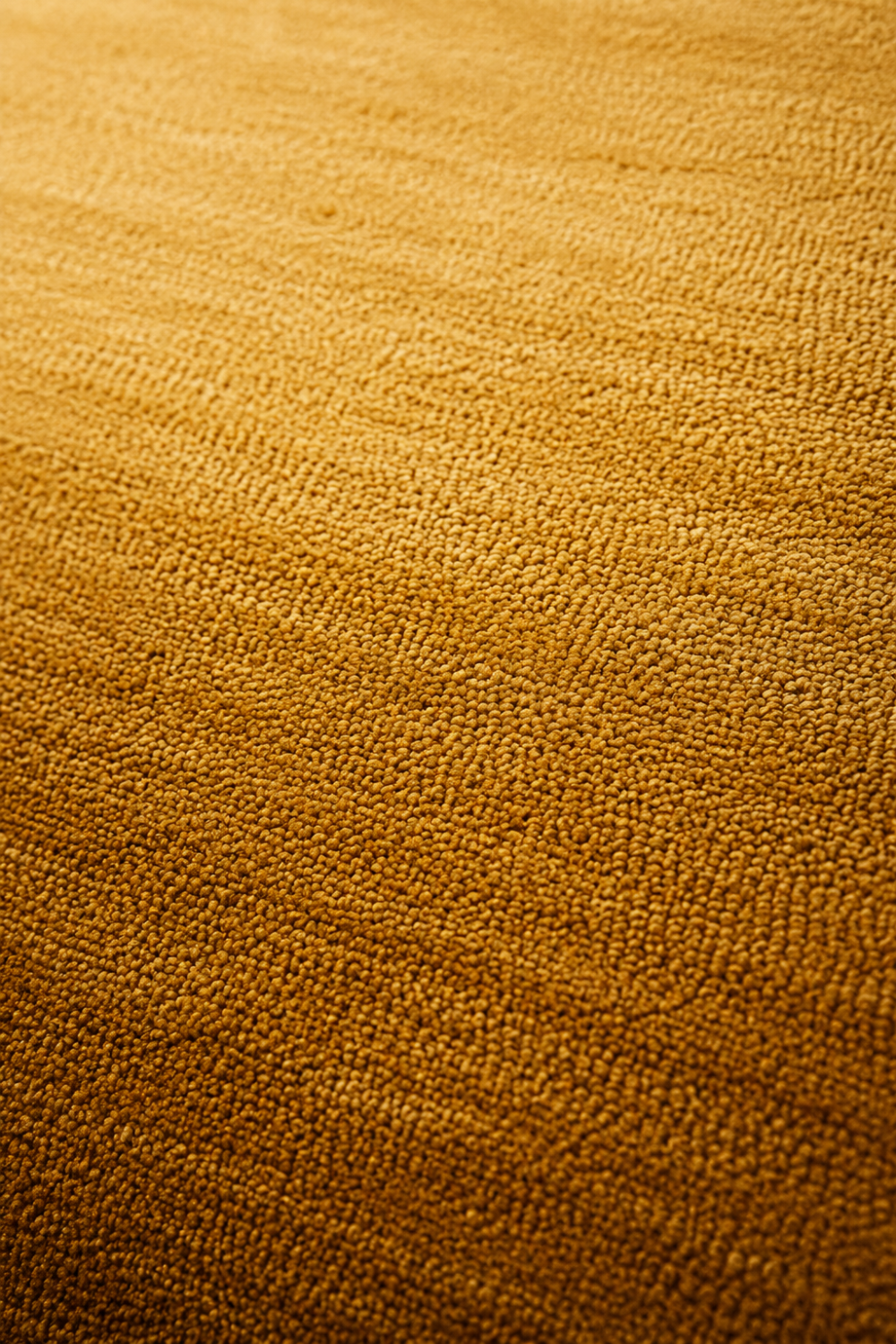 Close-up of the Golden Solstice handloom New Zealand wool rug showcasing its golden ombre texture and handcrafted weave.