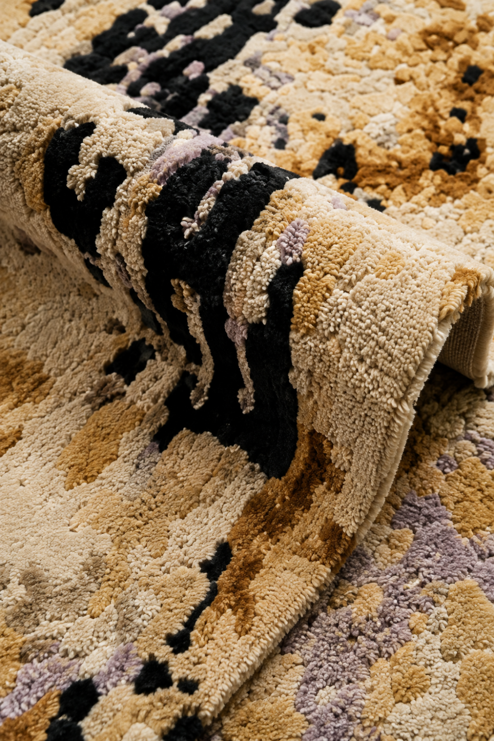 Close-up of Golden Trace abstract rug showing raised textured pile in ivory, gold, black and lavender tones