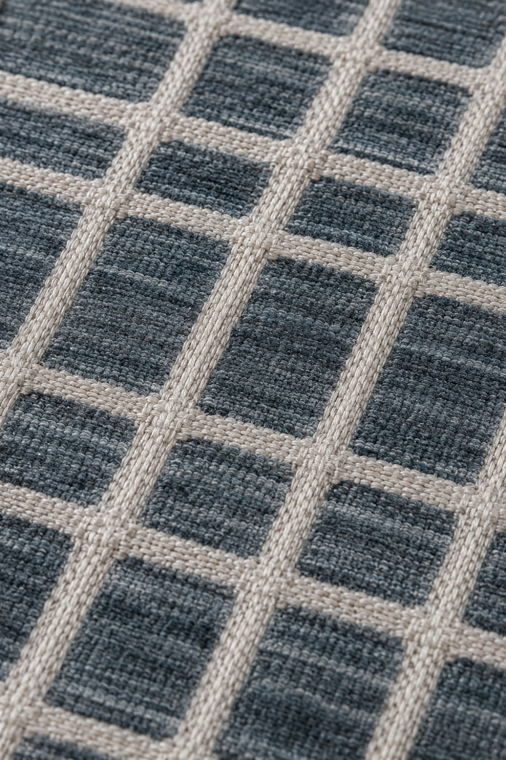 Close-up of the Harbor Grid handloom wool and viscose rug showcasing raised ivory grid detailing, premium woven texture and artisan craftsmanship