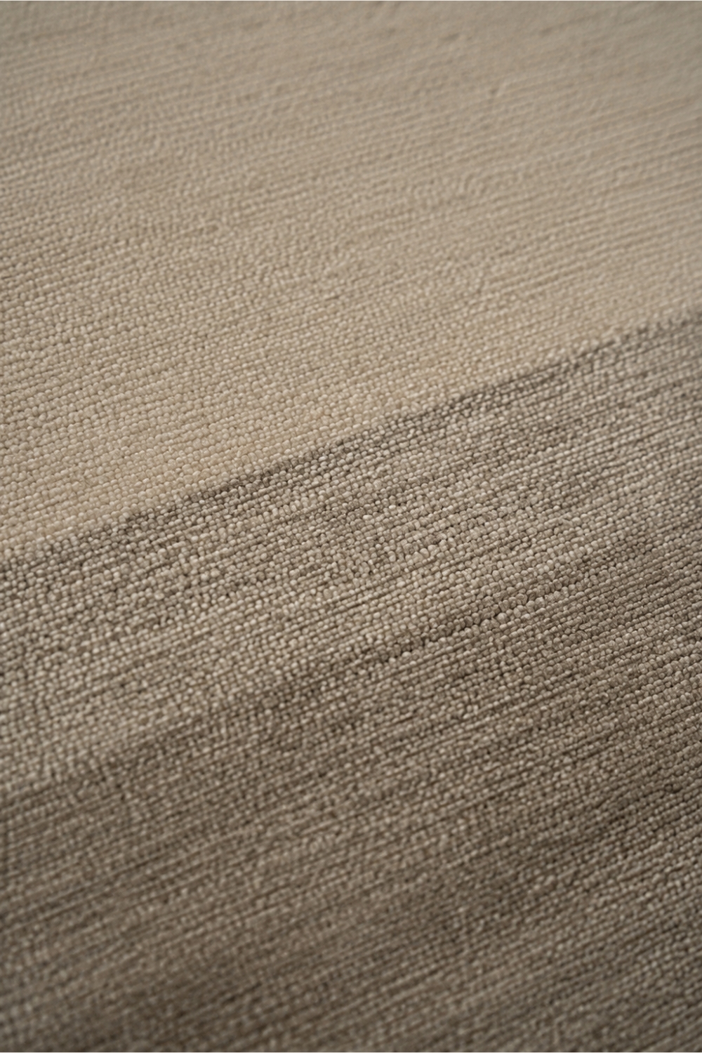 Close-up of the Ivory Horizon handloom New Zealand wool rug highlighting handcrafted texture and soft ivory to taupe tonal transition