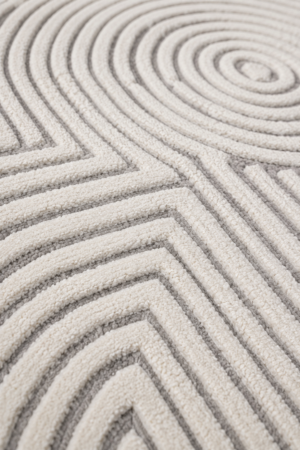 Close-up detail of Ivory Labyrinth rug highlighting premium high-low pile texture and handcrafted geometric pattern.