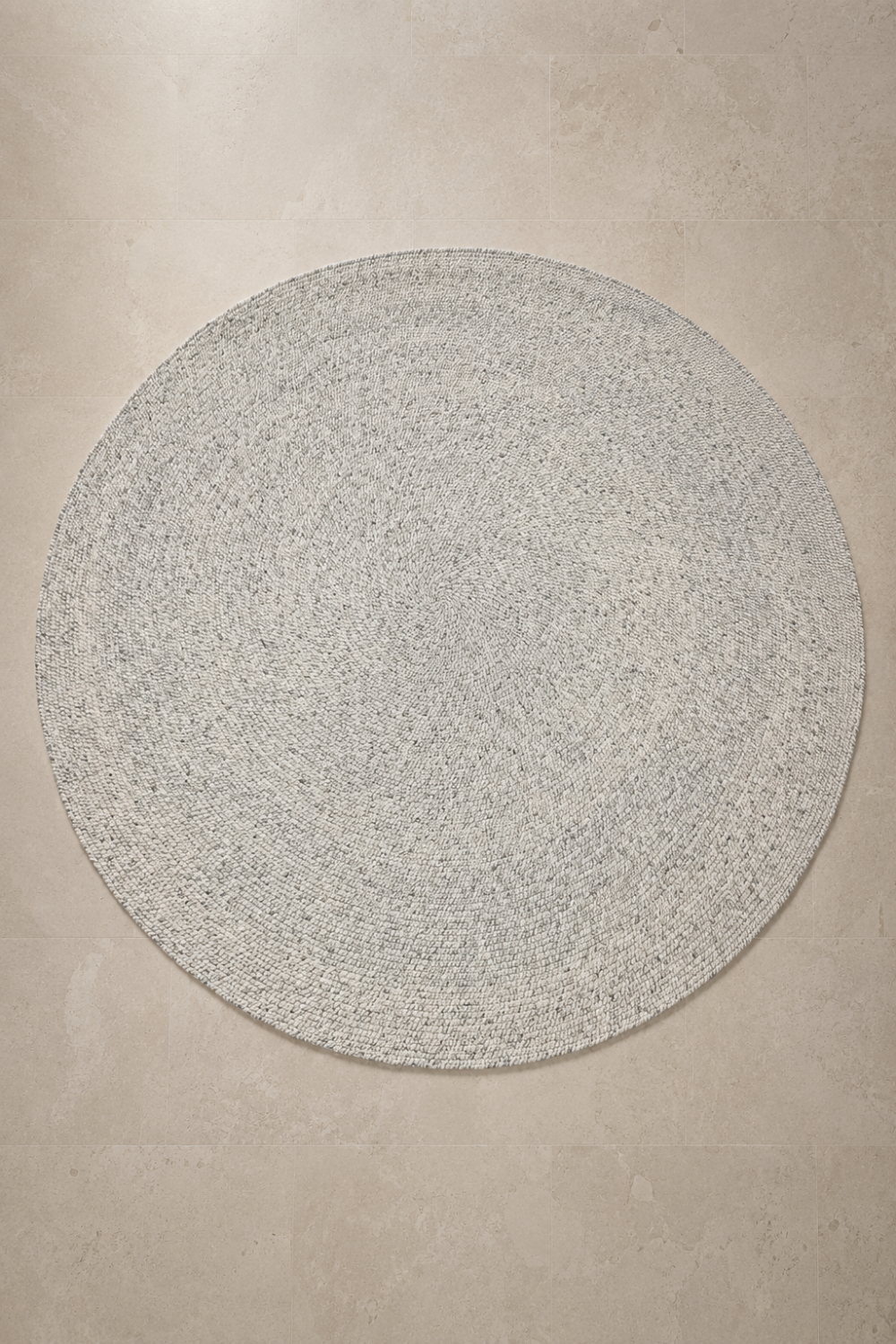 Ivory Loop Round Rug featuring a handwoven spiral texture in a soft ivory finish with subtle natural flecks.