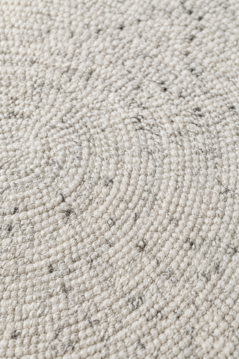Close-up of the Ivory Loop Round Rug highlighting its handcrafted spiral weave and soft textured surface.