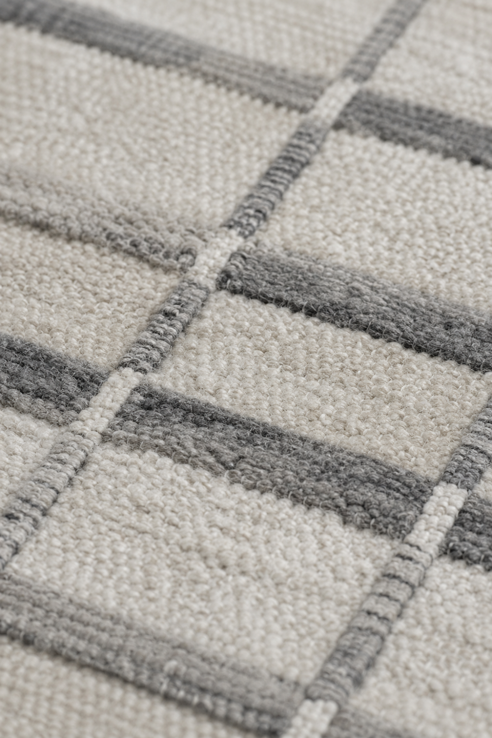 Close-up of the Linen Grid handloom wool and viscose rug showcasing fine grey linear detailing, woven texture and artisan craftsmanship