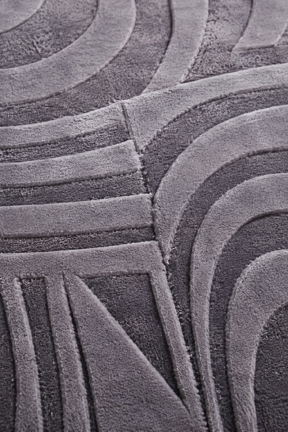 Close-up of the Lunar Arc Rug highlighting the embossed concentric arc texture and premium Handloom Viscose Tencel Bamboo craftsmanship.