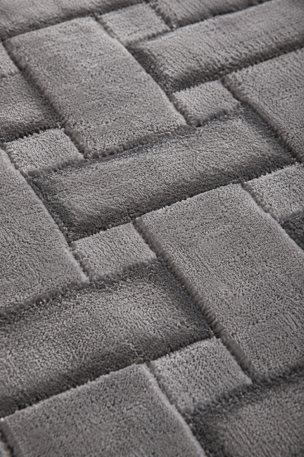 Close-up of the Metropolitan Weave Rug highlighting the raised basket-weave texture and premium Handloom Viscose Tencel Bamboo craftsmanship.