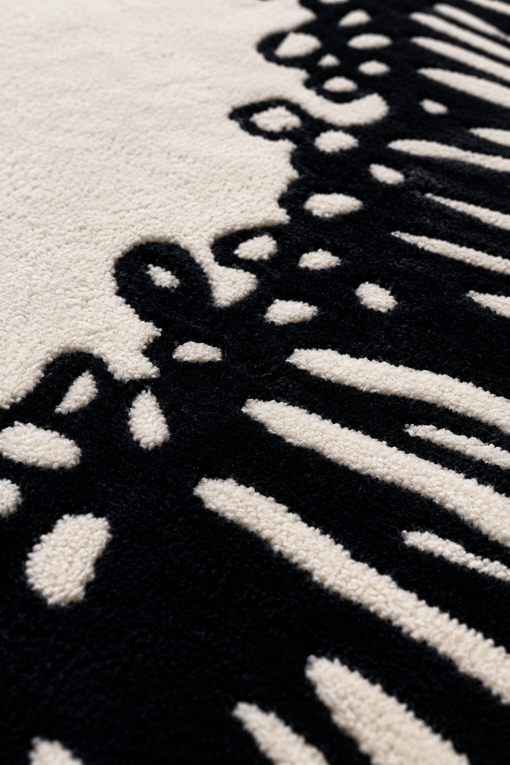 Close-up detail of Midnight Coral Organic Rug showcasing handcrafted texture, carved black pattern and premium luxury pile.