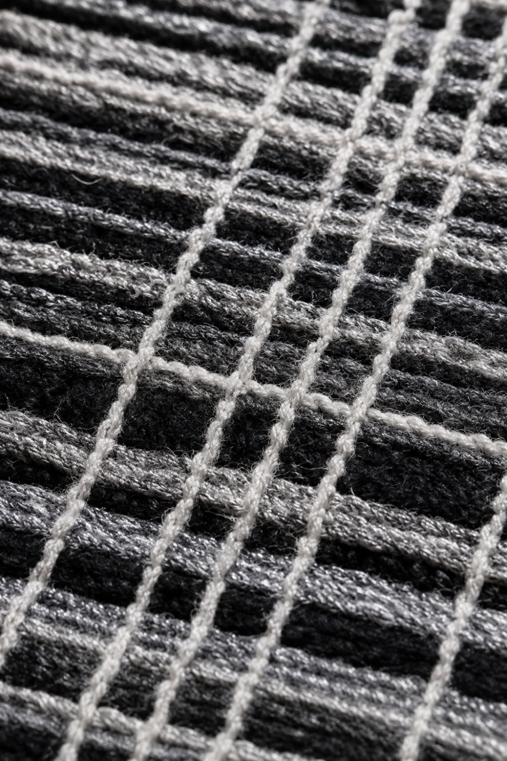 Close-up of the Midnight Weave handloom wool and viscose rug showcasing handcrafted linear texture raised weave and premium artisan detailing