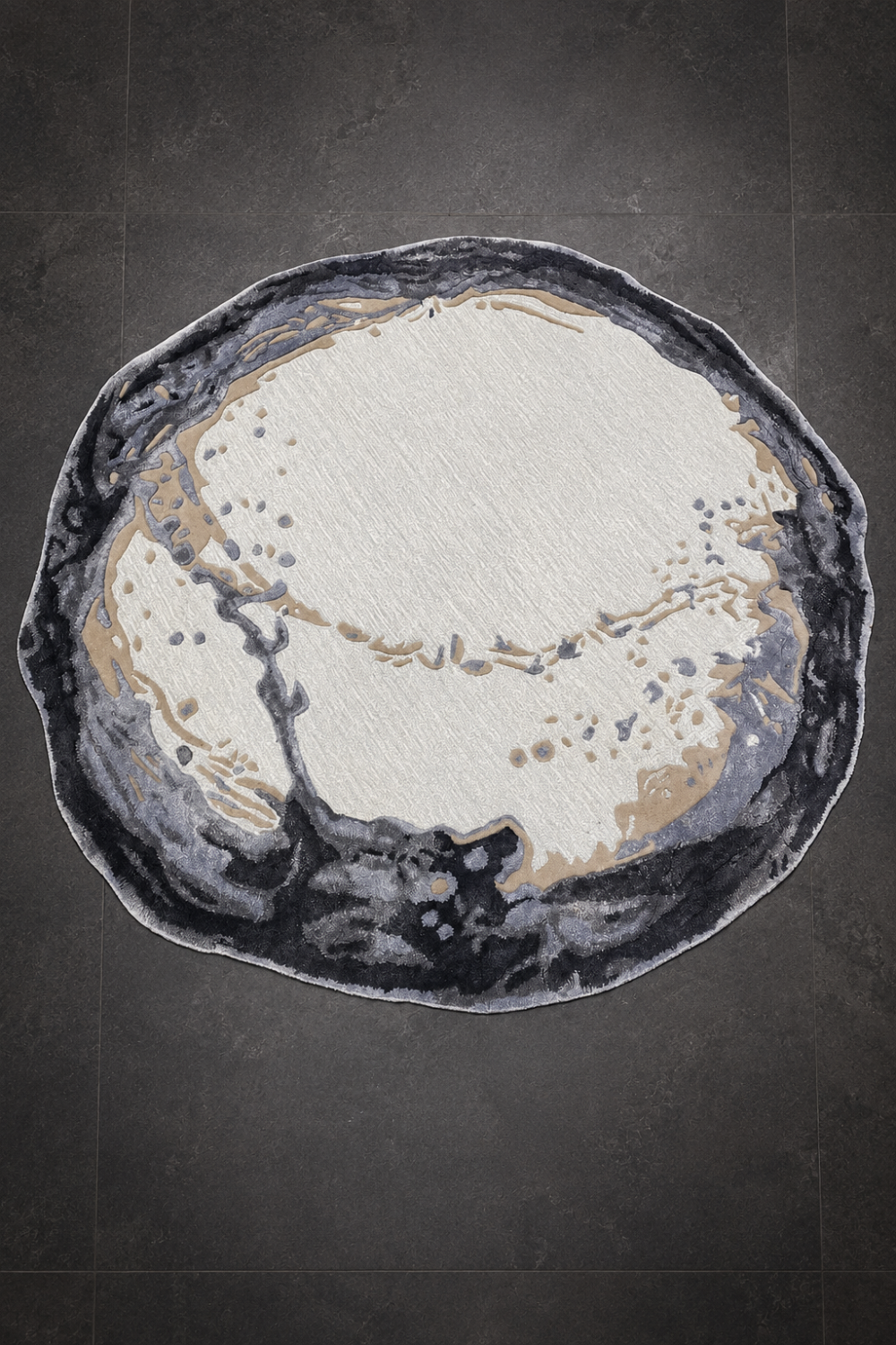 Obsidian Halo Round Rug featuring an organic abstract geode-inspired design in ivory, charcoal, grey, and warm sand tones with a sculpted textured surface.