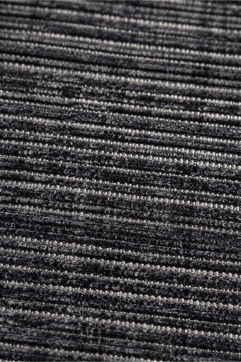 Close-up of the Obsidian Weave Handloom Plain Viscose rug highlighting the handcrafted ribbed weave and charcoal grey textured surface.