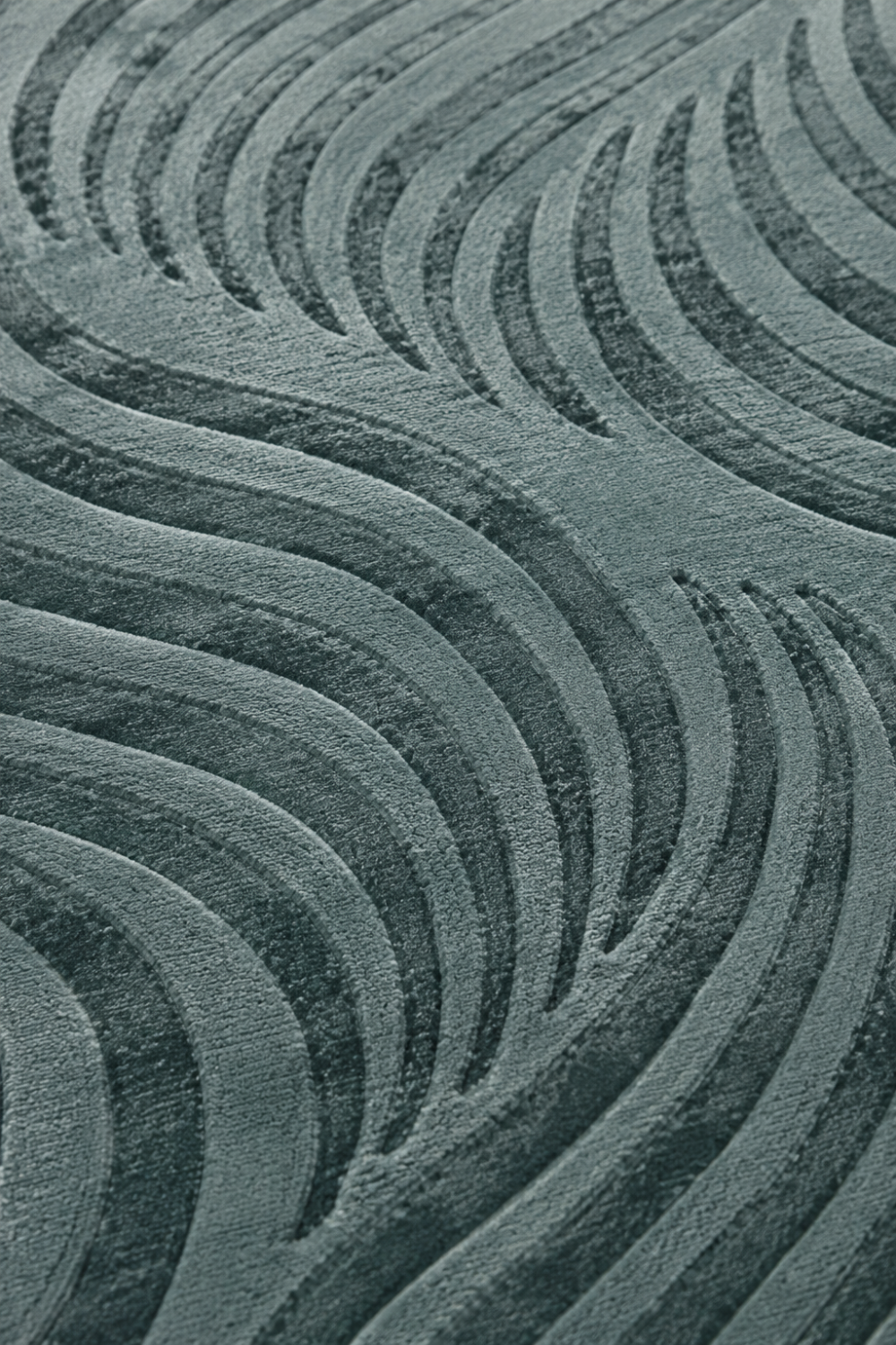 Close-up of the Ocean Current Rug showing carved flowing wave texture, raised detailing, and luxurious Handloom Viscose Tencel Bamboo surface.