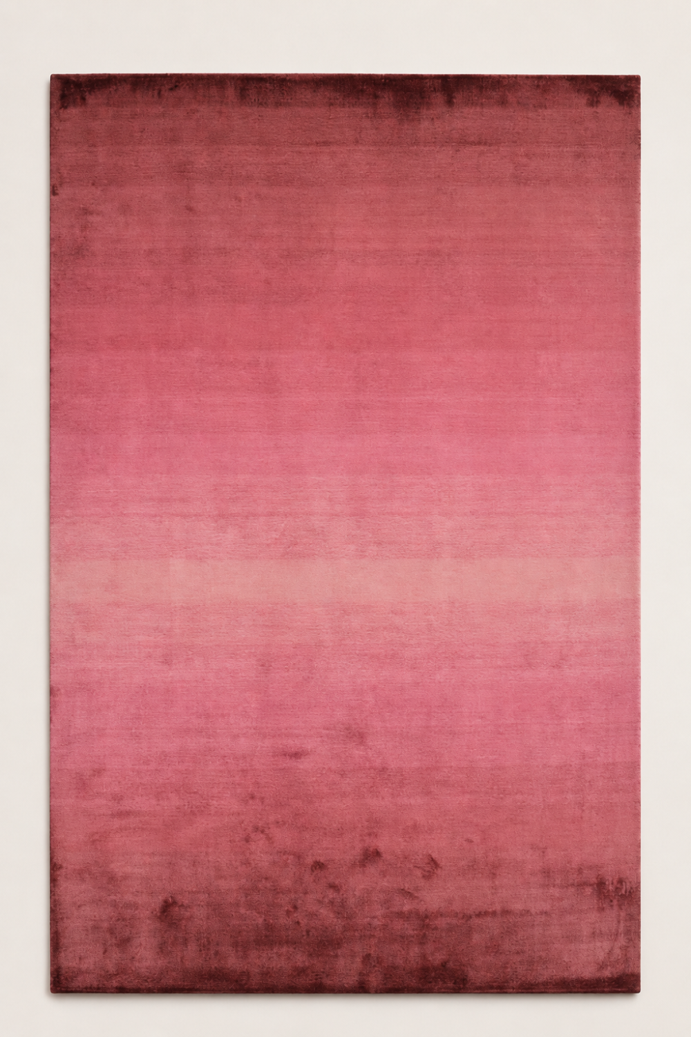Rose Horizon luxury handloom Tencel ombre pink area rug styled in a contemporary living room overlooking the ocean at sunset