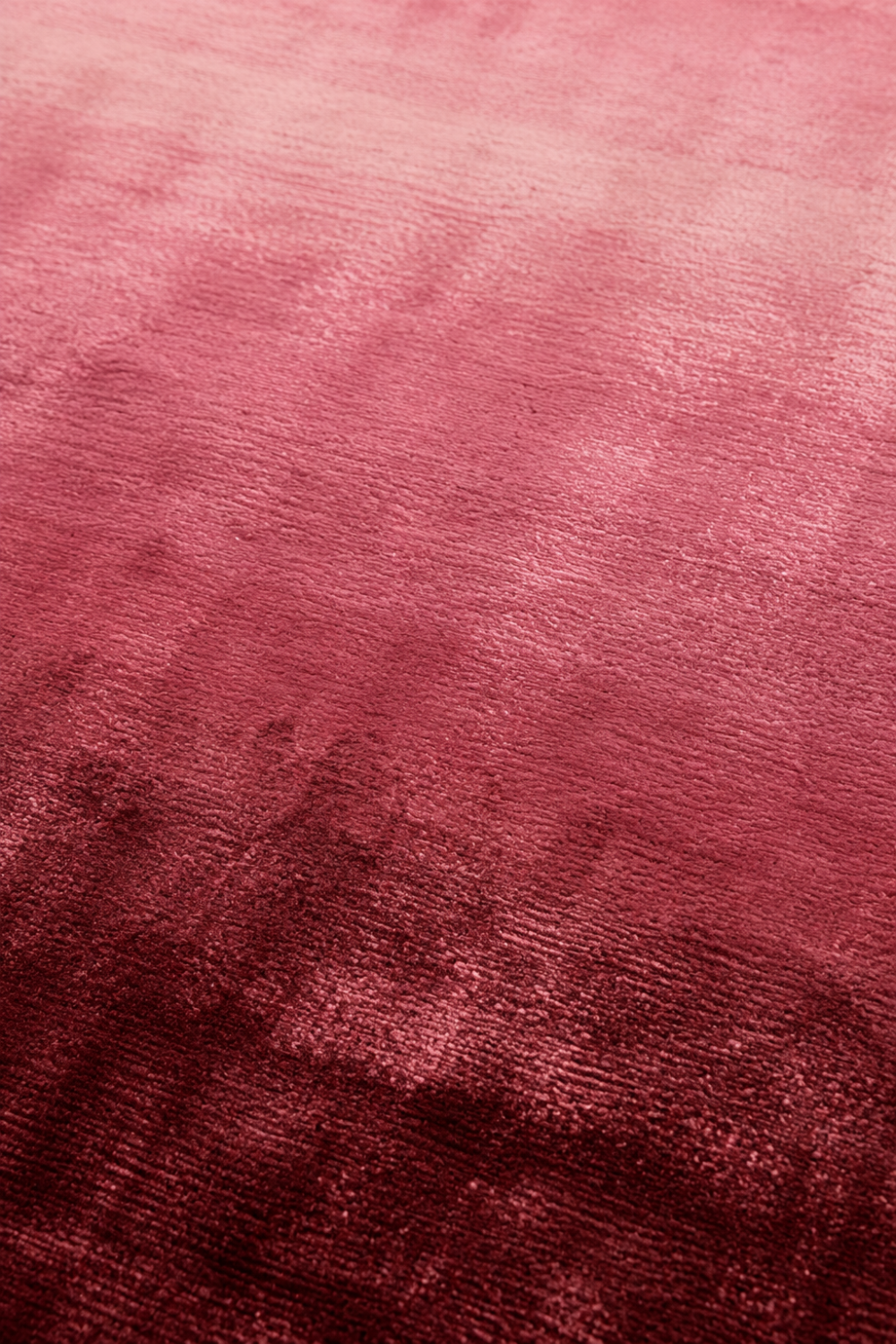 Close-up of the Rose Horizon handloom Tencel rug showcasing its smooth ombre gradient, silky texture and handcrafted finish