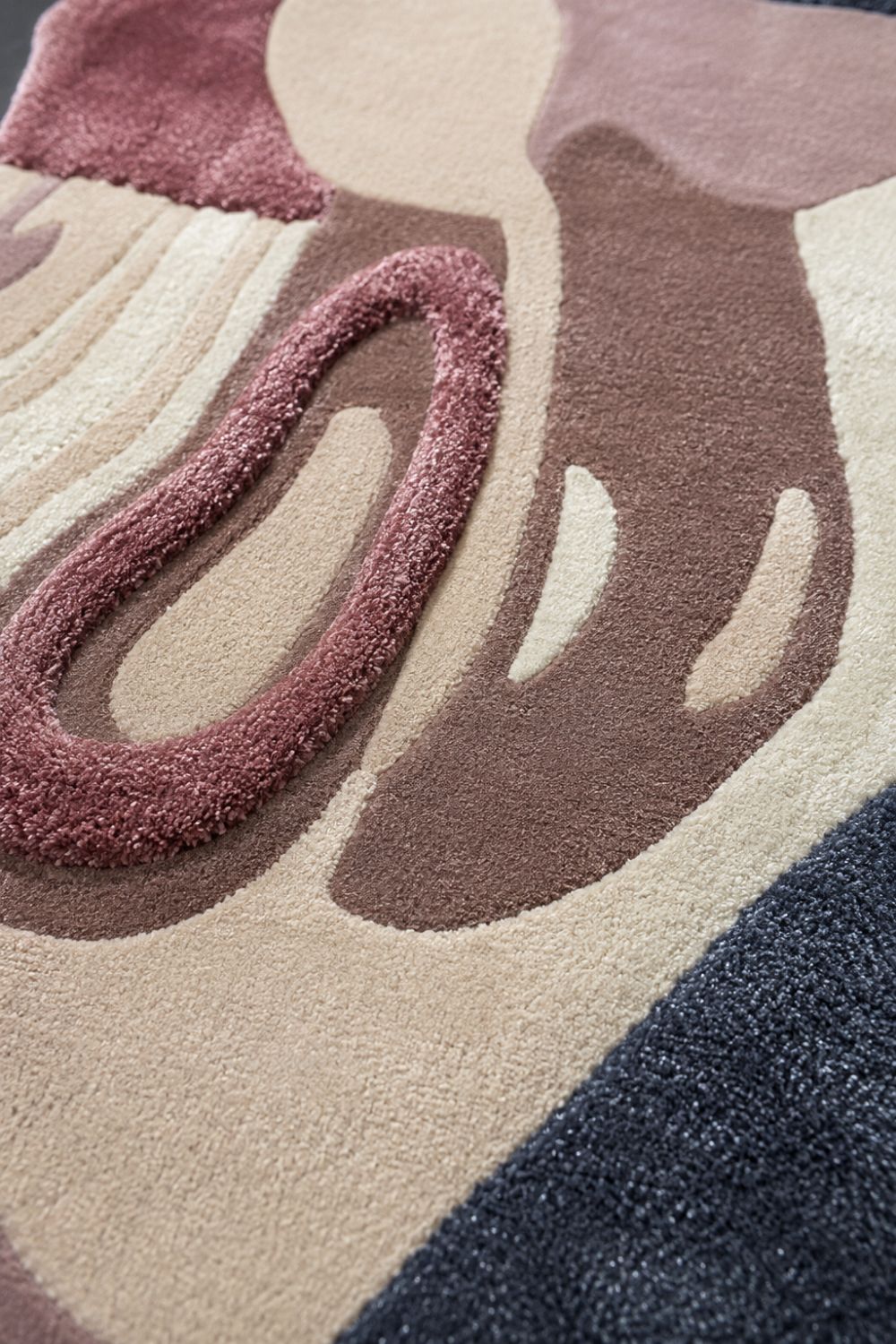 Close up texture detail of Rosé Mirage luxury hand tufted rug showing high low pile carving and premium craftsmanship