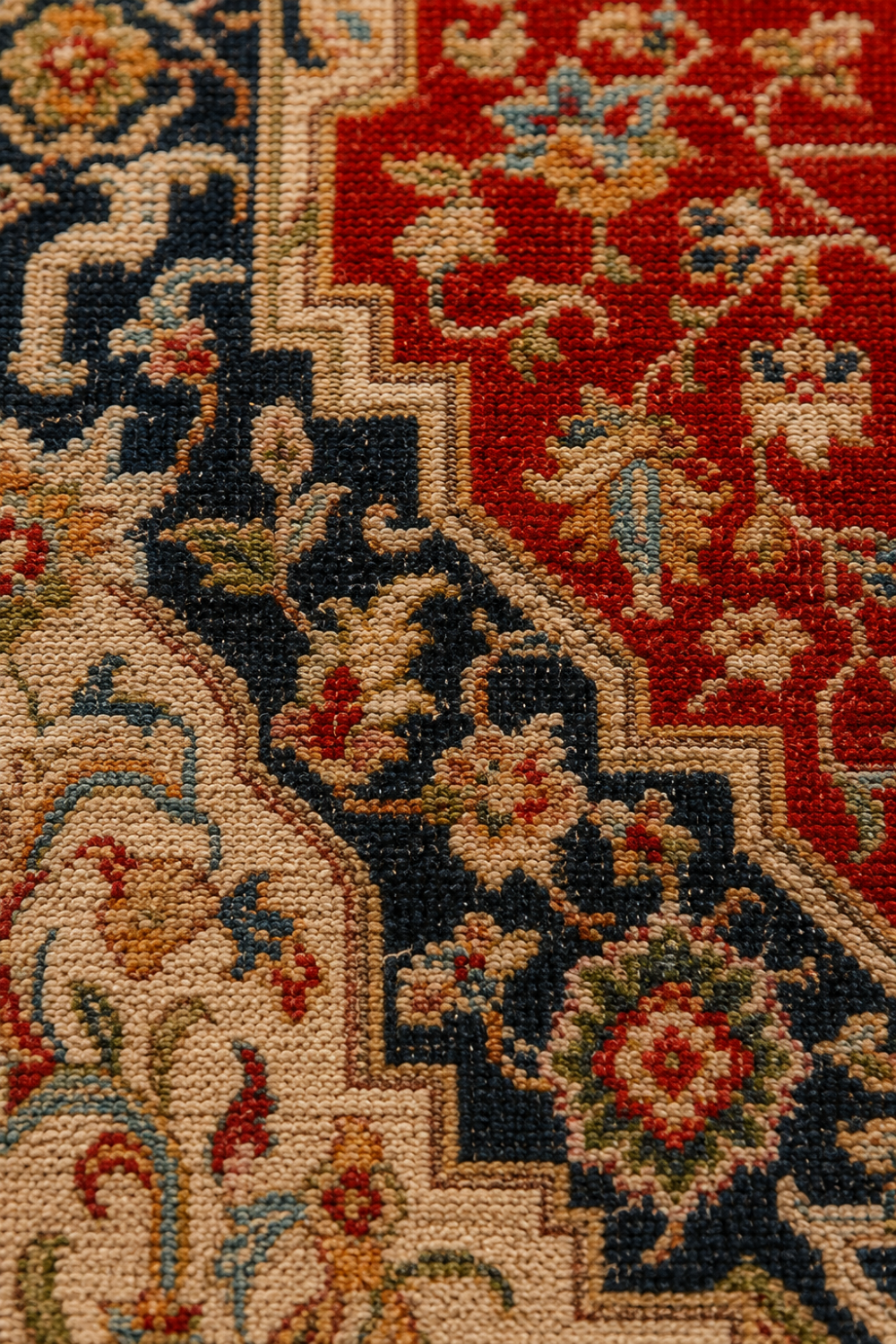 Close-up texture of the Royal Serapi Traditional Area Rug showcasing premium woven craftsmanship, intricate floral detailing, and rich terracotta red and navy colours.