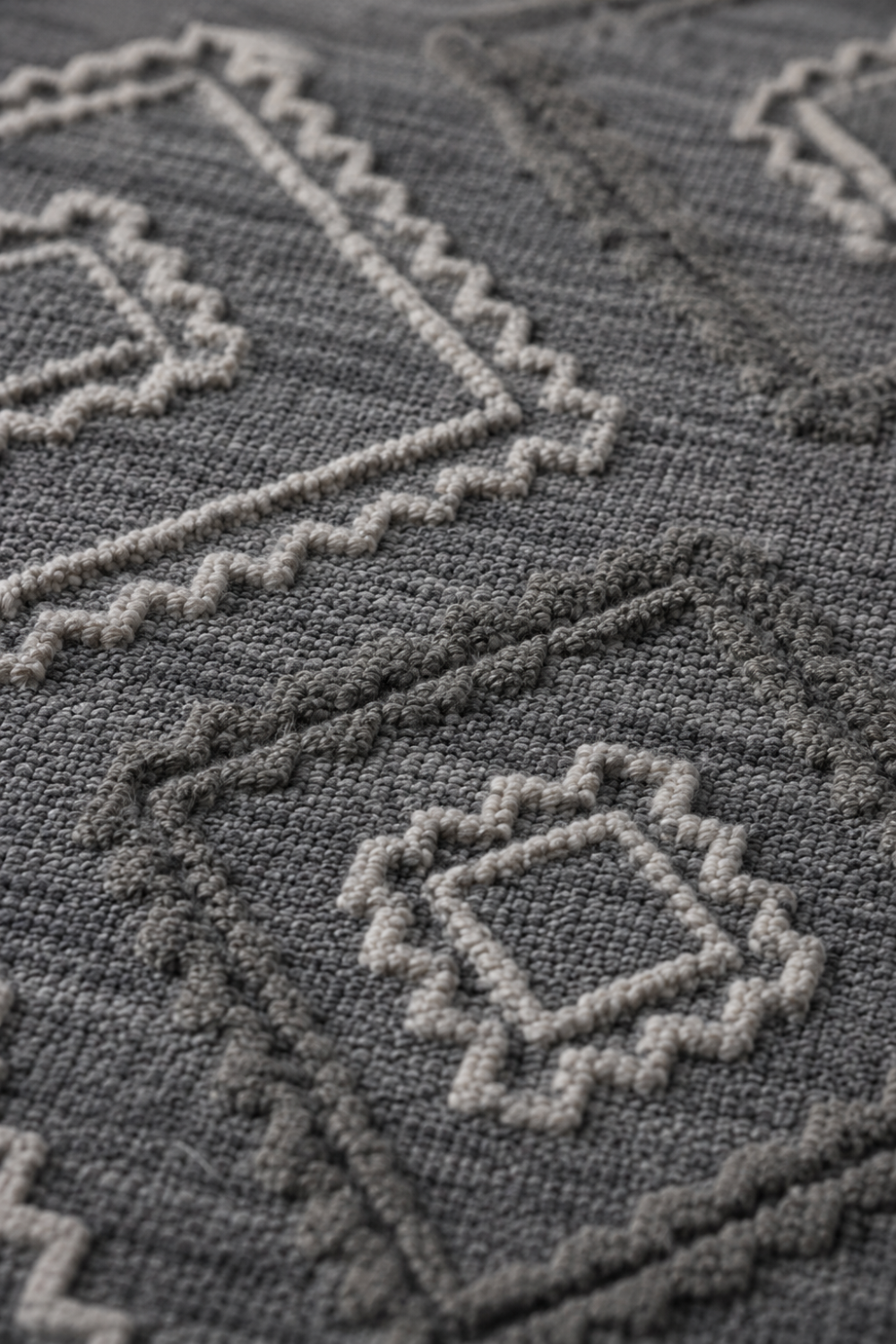 Close-up of the Sahara Crest handloom New Zealand Wool rug showcasing sculpted tribal geometric texture and artisan craftsmanship