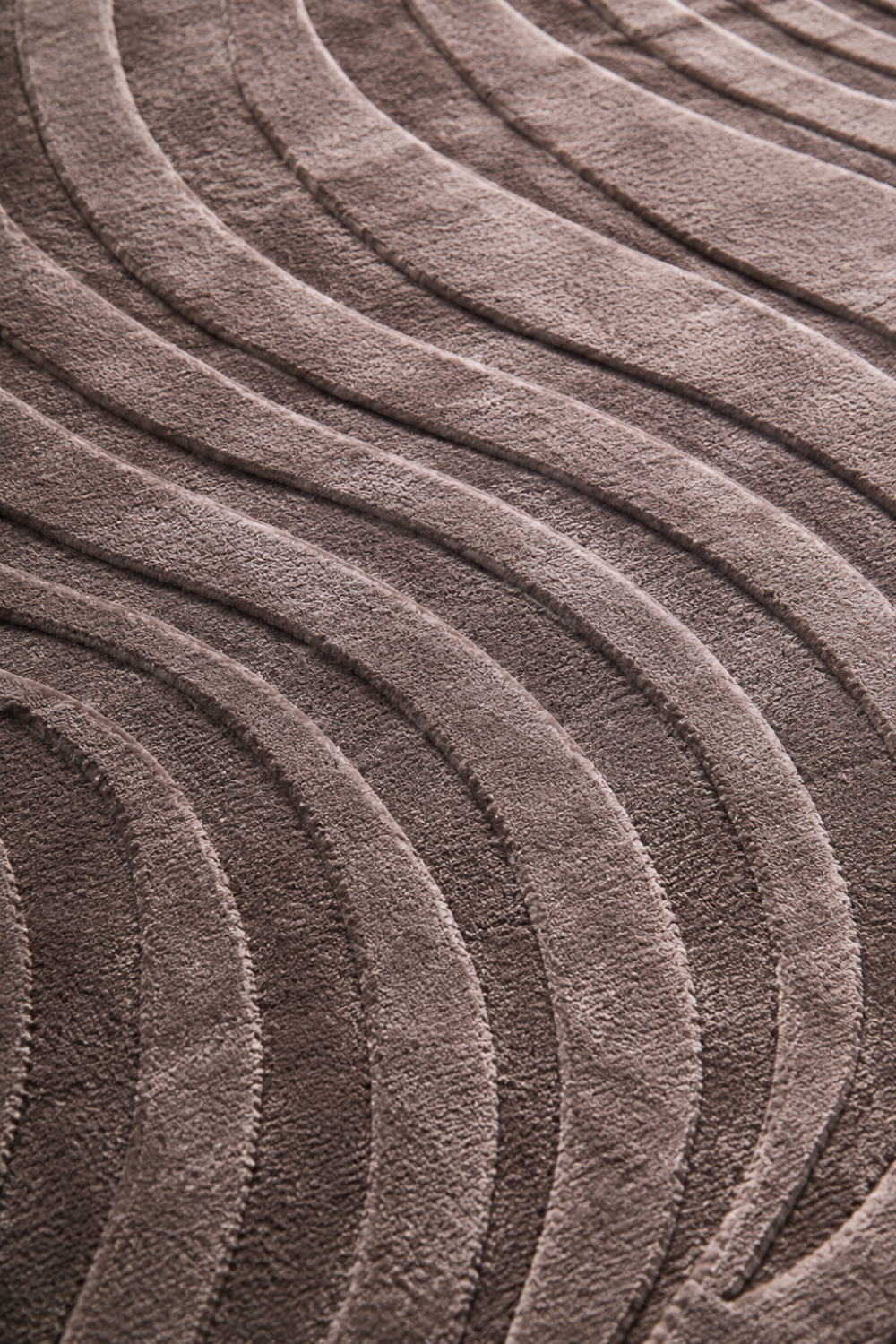 Close-up of the Sculpted Flow Rug highlighting the raised flowing wave texture and premium Handloom Viscose Tencel Bamboo craftsmanship.