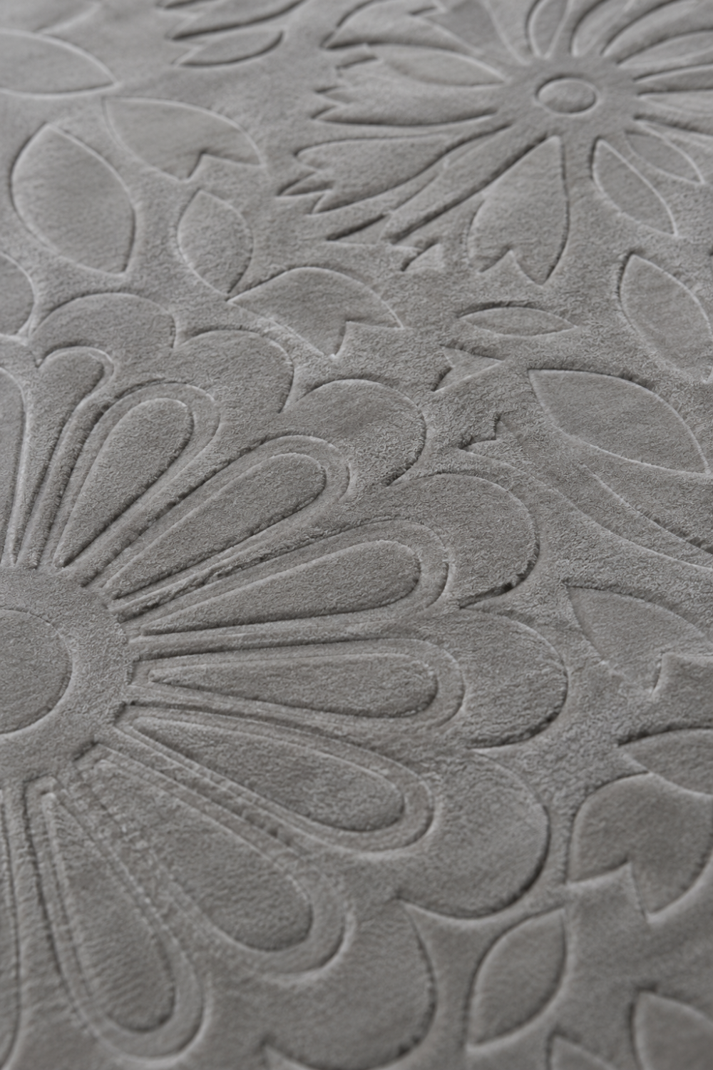 Close-up of the Silver Blossom Rug showing carved floral motifs, embossed botanical detailing, and luxurious Handloom Viscose Tencel Bamboo texture.