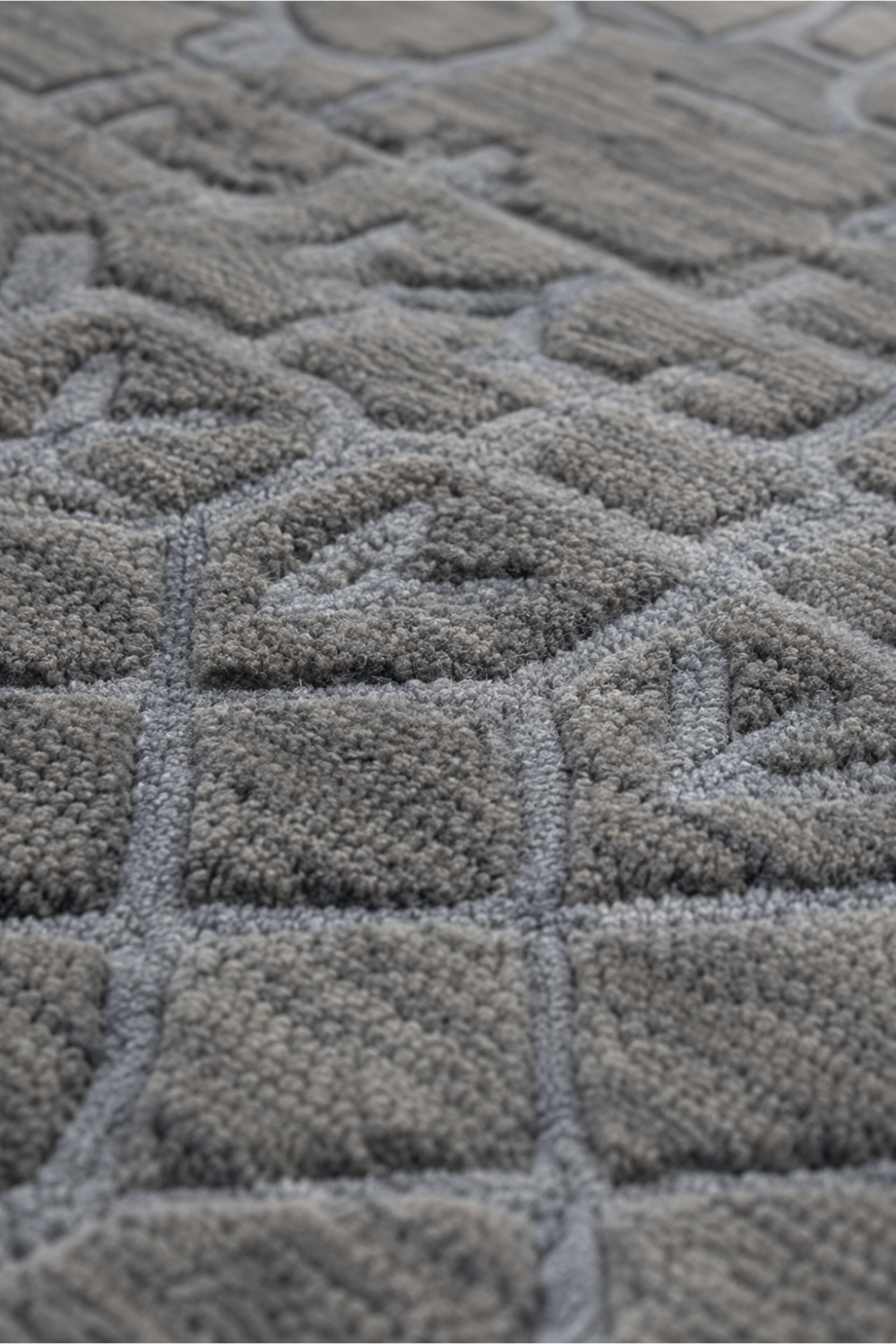Close-up of the Silver Haven handloom over hand tufted New Zealand wool rug showcasing raised geometric carved texture and handcrafted detailing