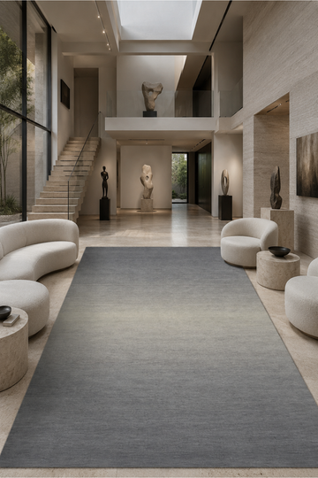 Silver Mist Gradient luxury handloom New Zealand wool rug styled in a modern minimalist living room with soft grey and ivory ombré tones.