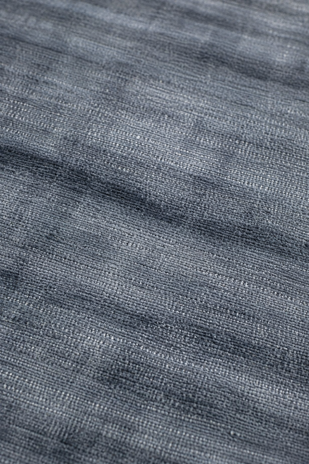 Close-up of the Slate Haven Handloom Plain Viscose rug showing handcrafted weave, soft texture and slate blue-grey tonal variation.