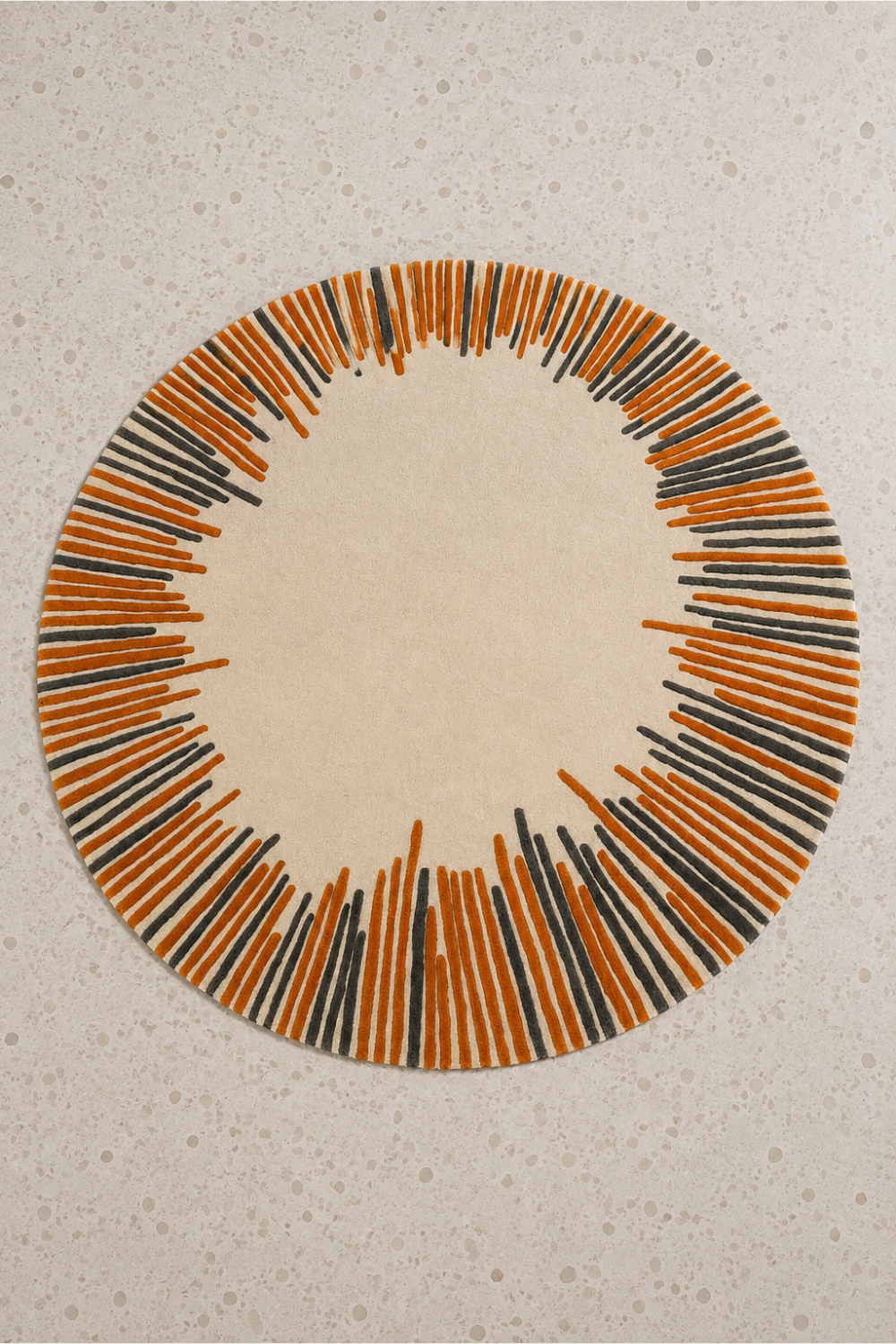 Solar Pulse Round Hand Tufted Rug featuring an ivory center with burnt orange and charcoal radial border design.