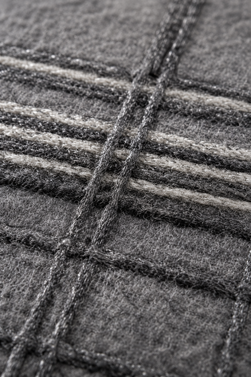 Close-up of the Sterling Grid handloom wool and viscose rug showcasing raised viscose detailing, handcrafted plaid texture and premium artisan weaving