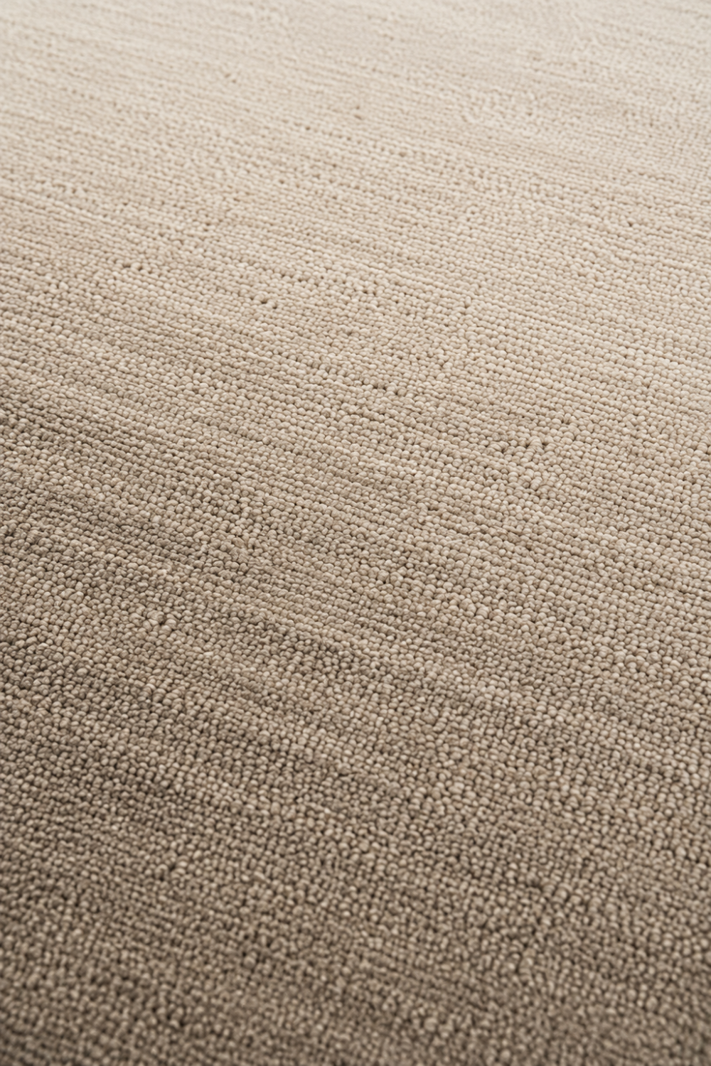 Close-up of the Stone Haven handloom New Zealand wool rug showcasing its warm greige ombre texture and handcrafted weave.