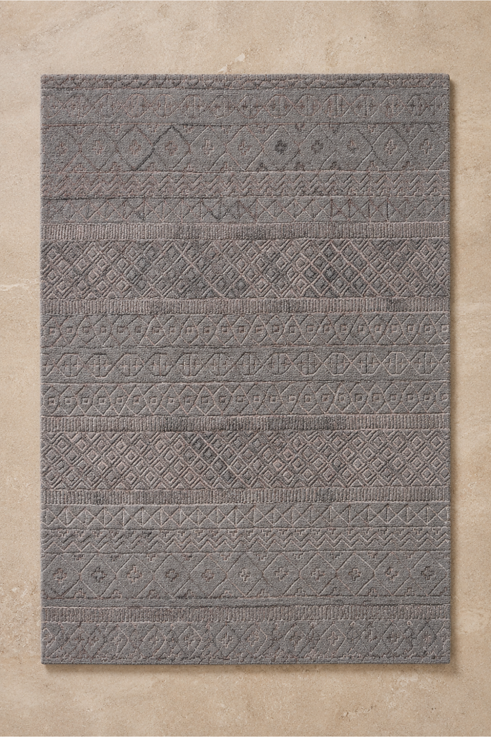 Stone Mosaic handcrafted handloom over hand tufted grey geometric New Zealand wool area rug featuring carved tribal bands on a neutral background