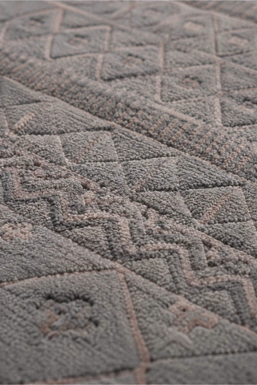 Close-up of the Stone Mosaic handloom over hand tufted New Zealand wool rug showcasing raised geometric carvings and handcrafted textured details