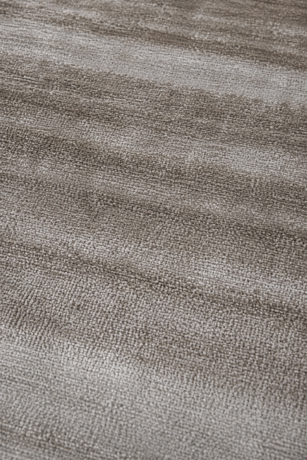 Close-up texture of the Stone Veil Rug showcasing handcrafted handloom viscose fibers, refined silky finish, and warm greige tonal detailing.