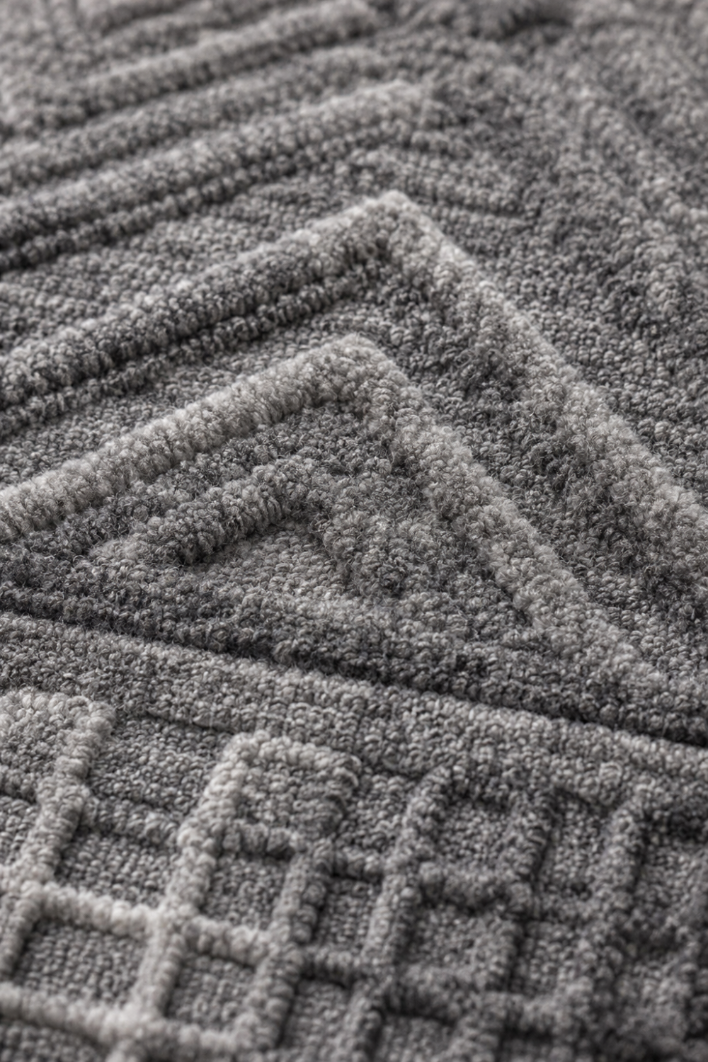 Close-up of the Summit Echo handloom over hand tufted New Zealand wool rug showcasing raised geometric carving and handcrafted wool texture