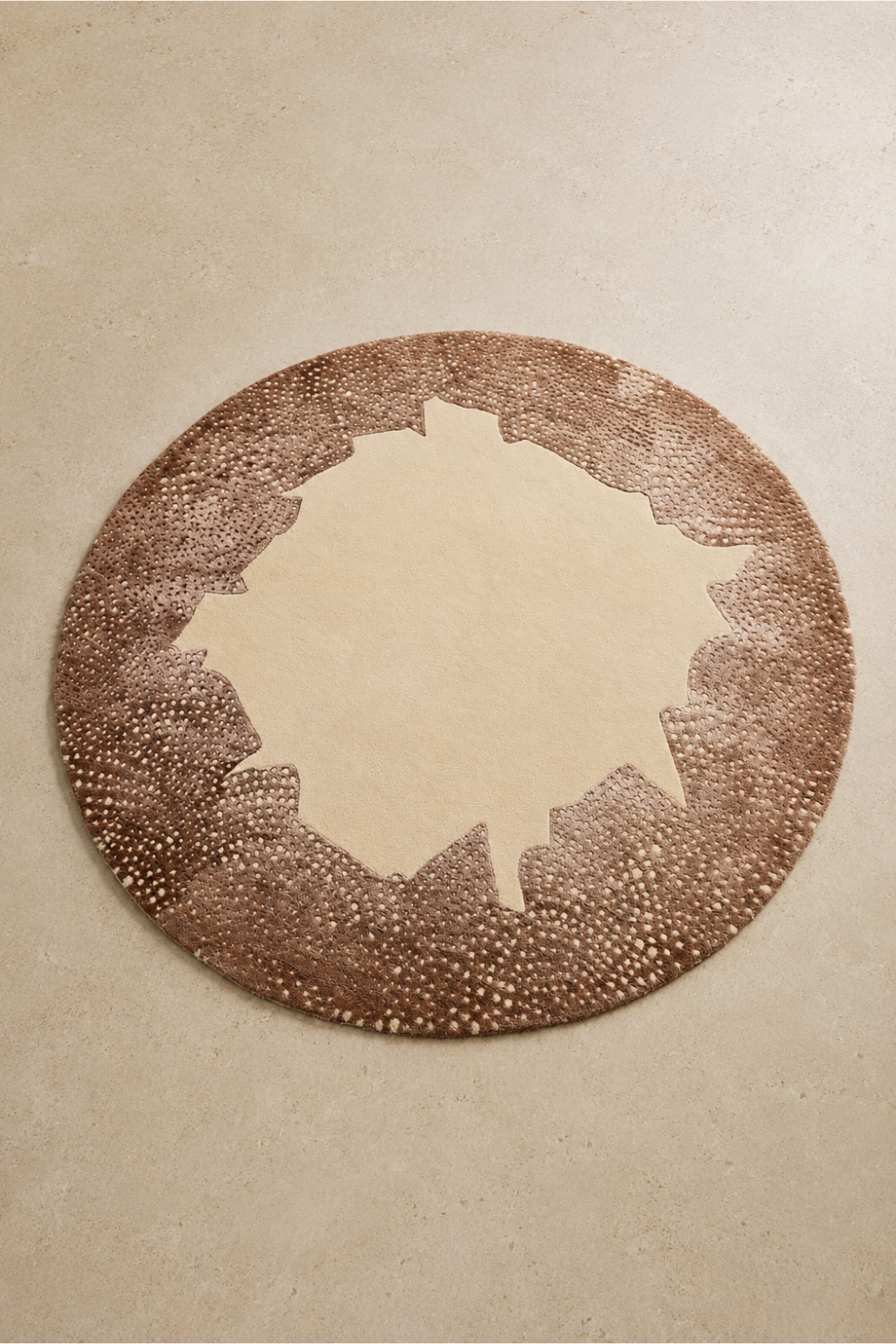 Terra Halo Round Hand Tufted Rug featuring a soft ivory center with an artistic mocha speckled border.