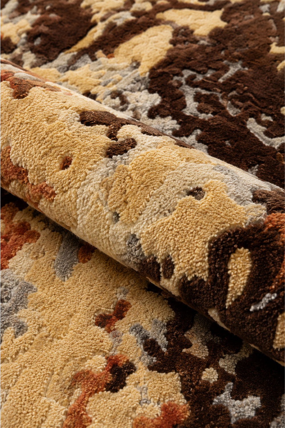 Close-up of Terra Veil rug showing tactile hand-tufted pile with cream, brown, grey and rust abstract detailing