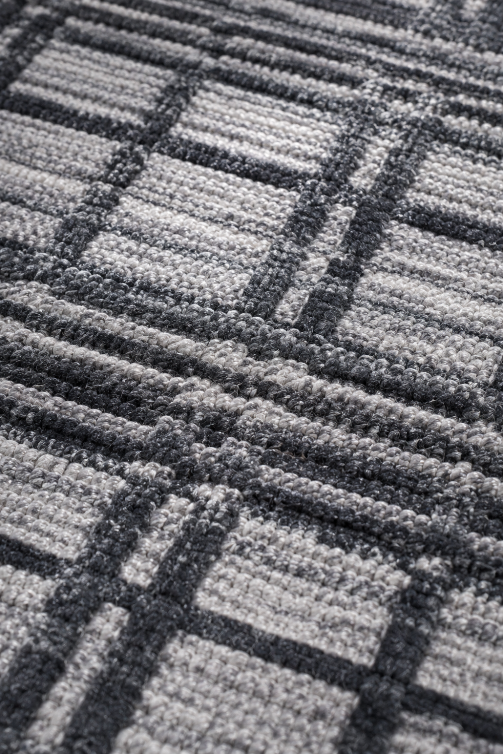 Close-up of the Urban Grid handloom wool and viscose rug highlighting raised grid lines, premium woven texture, and handcrafted detailing